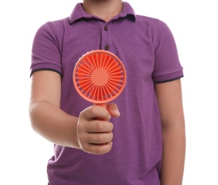 Photo of Little boy with portable fan on white background, closeup. Summer heat