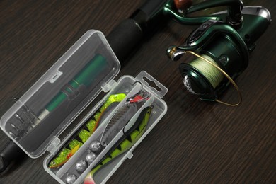 Photo of Fishing tackle on dark wooden background, above view