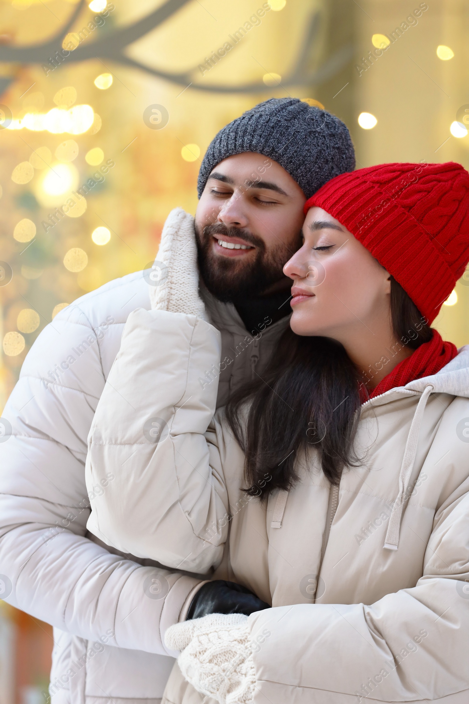 Photo of Portrait of lovely couple outdoors against blurred lights outdoors