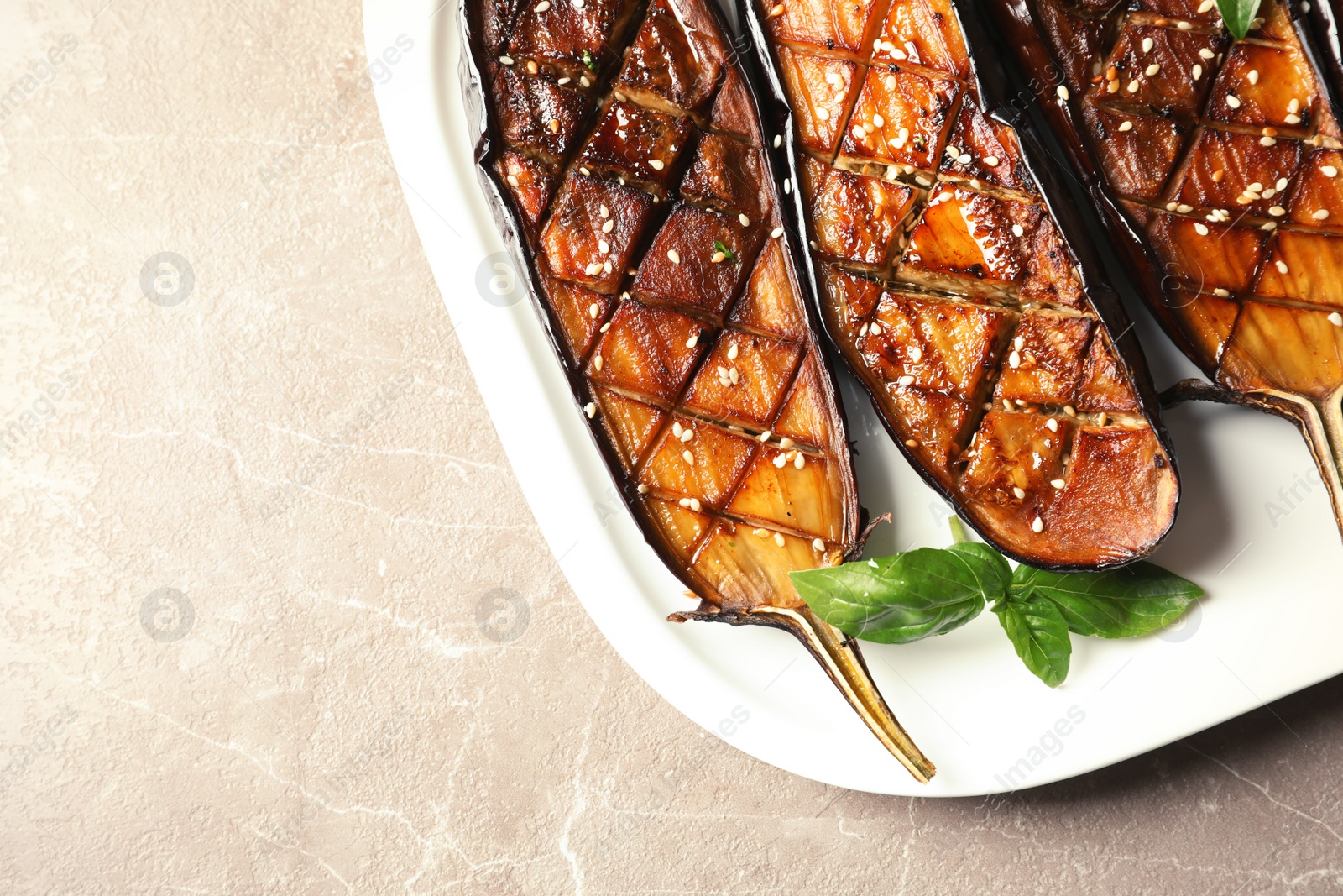 Photo of Plate with fried eggplant slices on table, closeup. Space for text