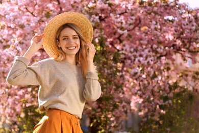 Photo of Young woman wearing stylish outfit in park on spring day. Fashionable look