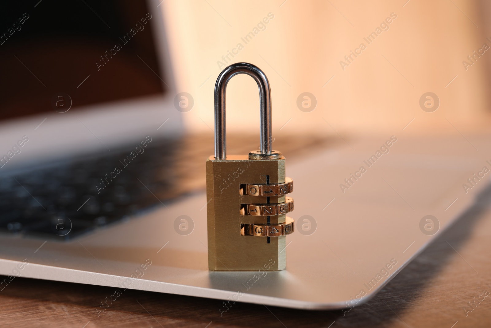 Photo of Cyber security. Laptop with padlock on table, closeup