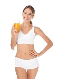 Photo of Happy slim woman in underwear holding glass of juice on white background. Weight loss diet