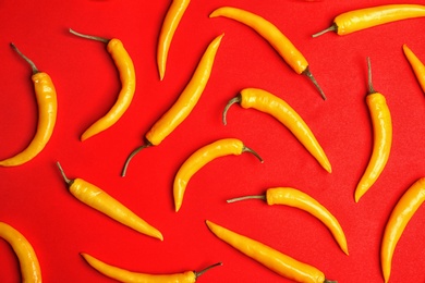 Flat lay composition with chili peppers on color background