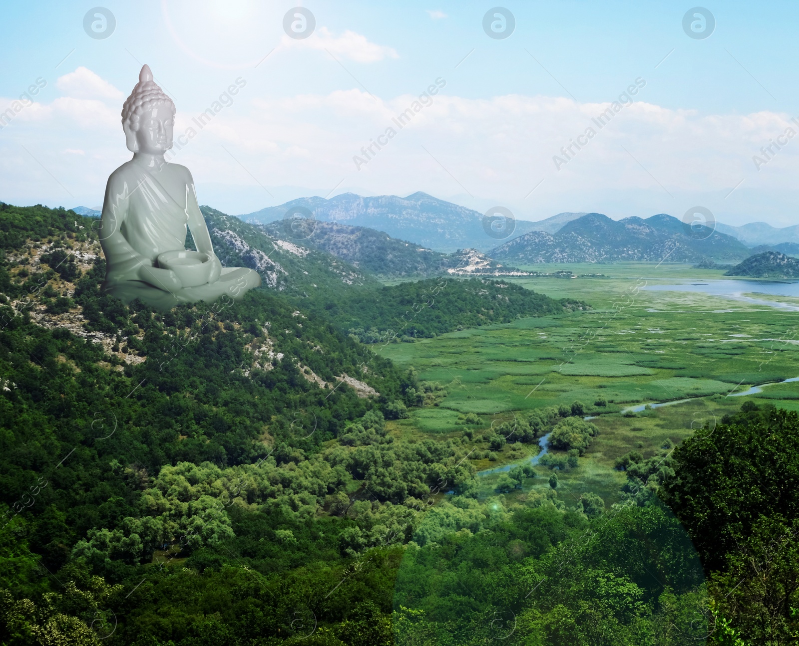 Image of Majestic Buddha sculpture rising above picturesque mountains on sunny day 