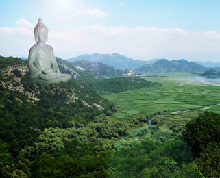 Image of Majestic Buddha sculpture rising above picturesque mountains on sunny day 