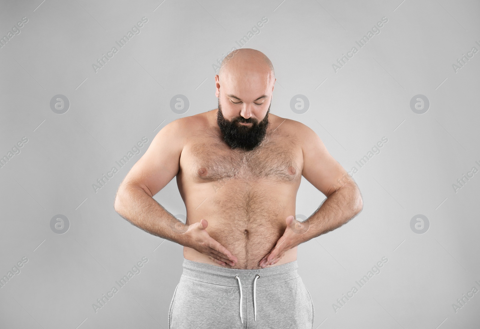 Photo of Fat man on grey background. Weight loss