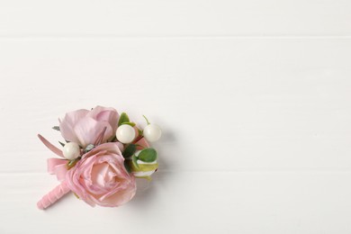 Photo of Beautiful boutonniere on white background, top view. Space for text