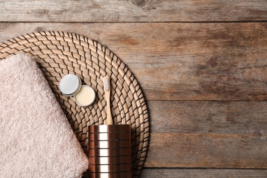 Flat lay composition with bamboo toothbrush and space for text on wooden background