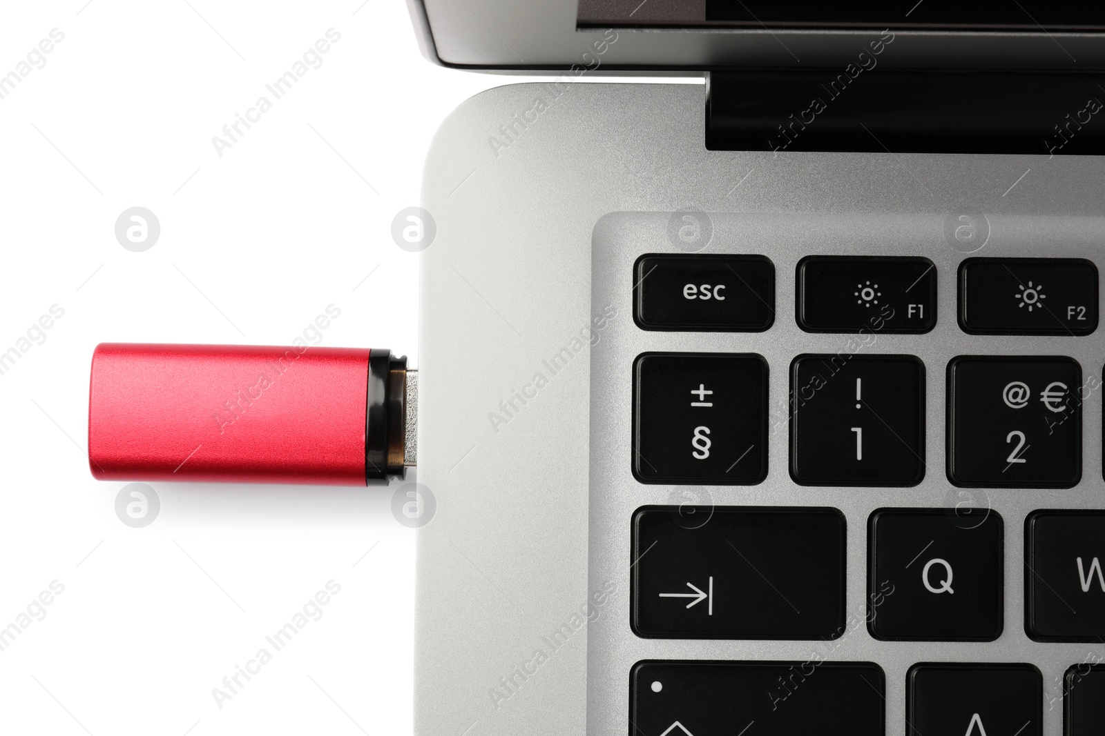 Photo of Usb flash drive attached into laptop on white background, top view