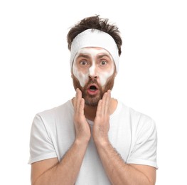 Emotional man with headband washing his face on white background