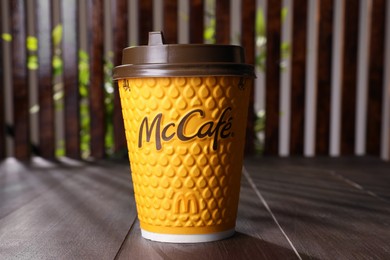 MYKOLAIV, UKRAINE - AUGUST 12, 2021: Hot McDonald's drink on wooden table