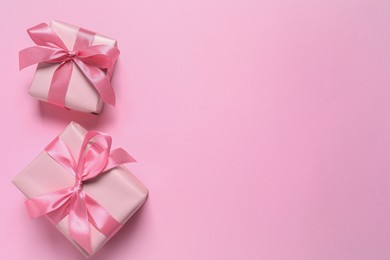Photo of Beautiful gift boxes on pink background, flat lay. Space for text