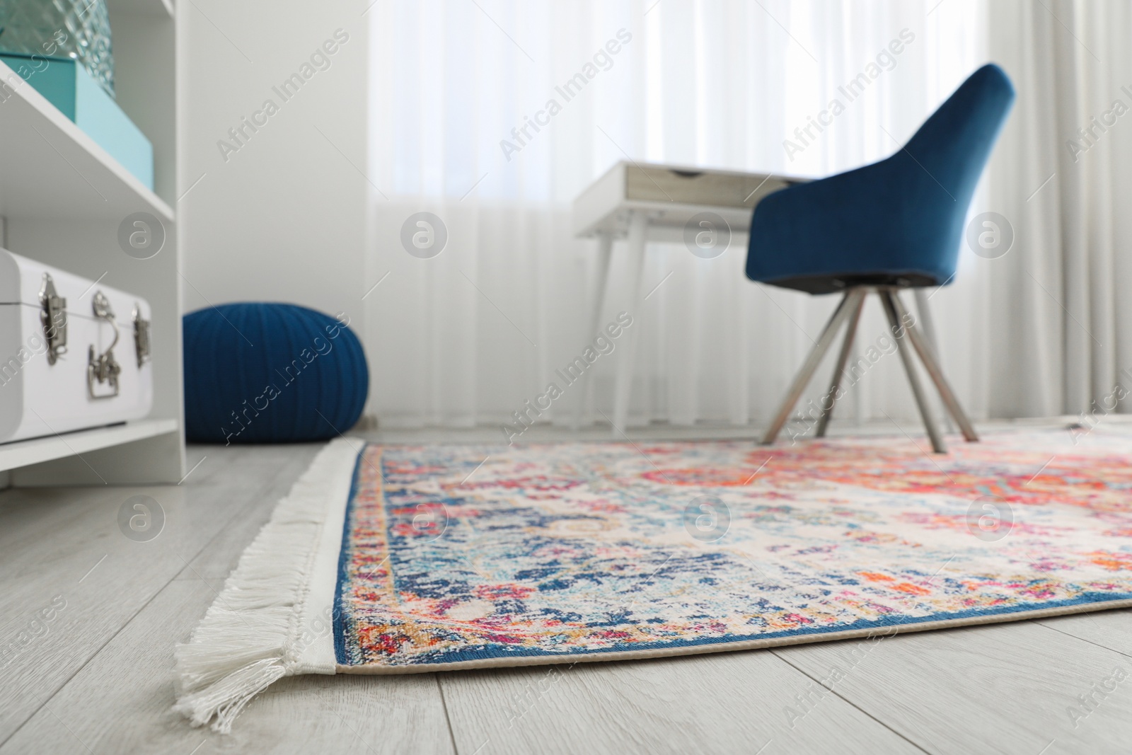 Photo of Stylish rug and furniture in room, low angle view. Interior design