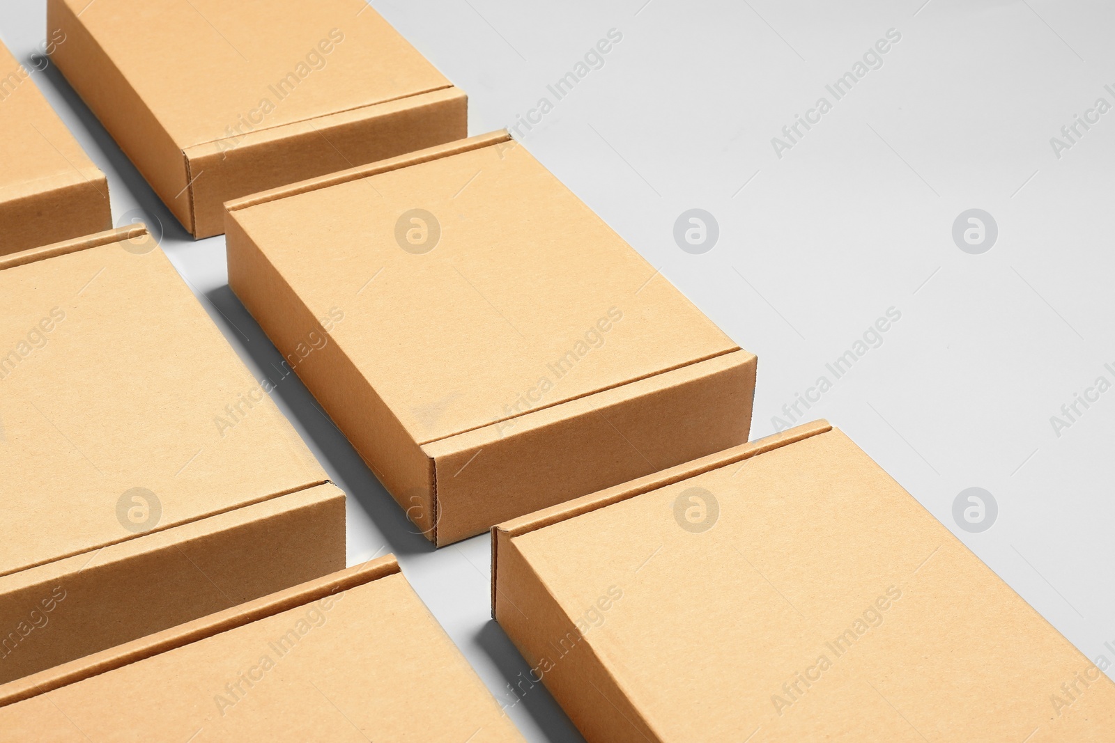 Photo of Many cardboard boxes on white background, space for text. Packaging goods