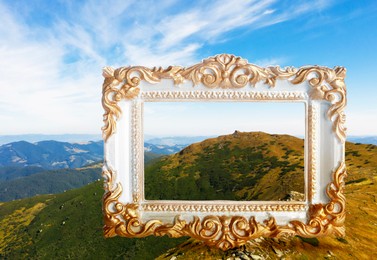 Image of Vintage frame and beautiful mountains under blue sky with clouds