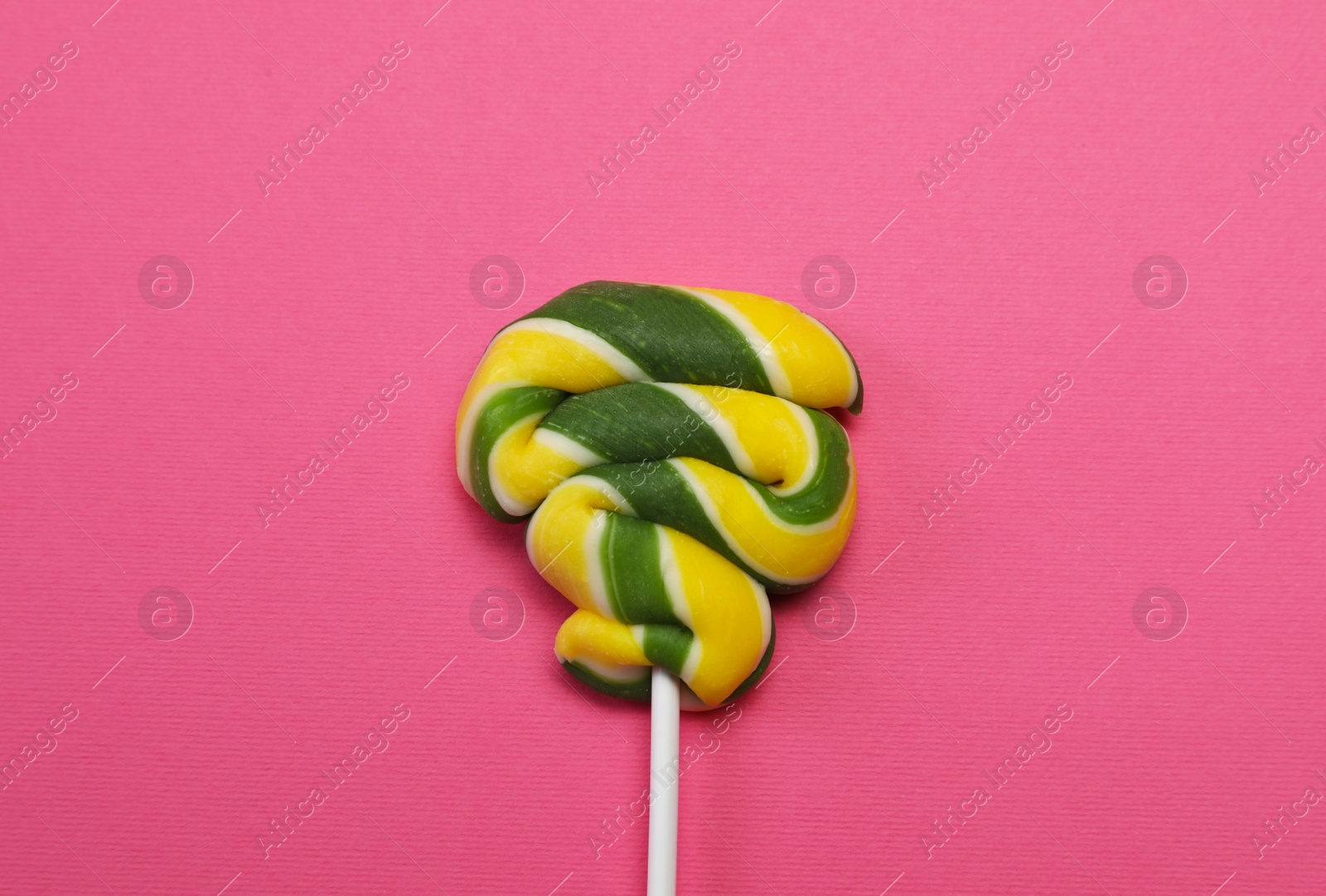 Photo of Sweet colorful lollipop on pink background, top view