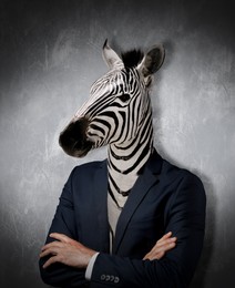 Portrait of businessman with zebra face on dark background