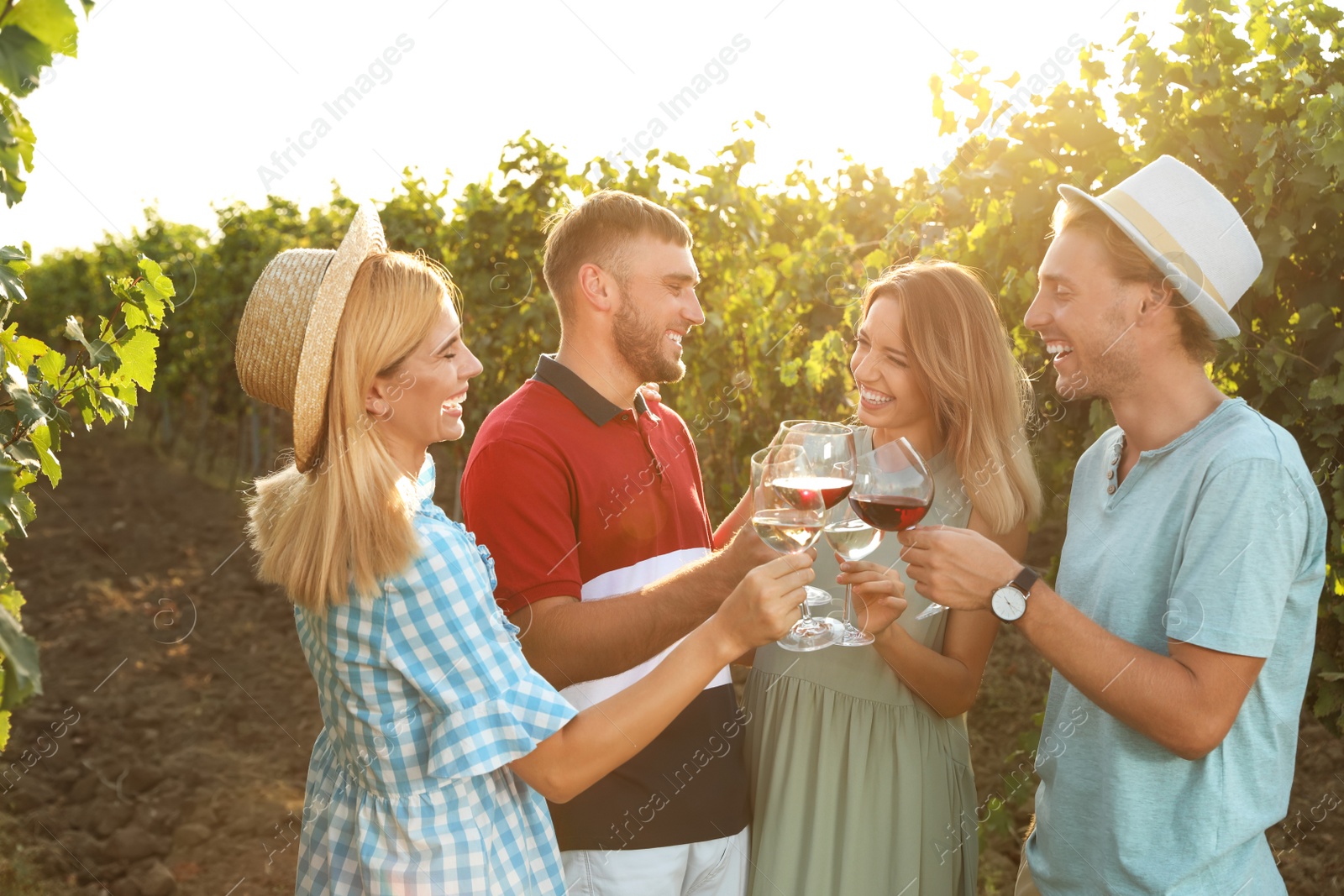 Photo of Friends drinking wine and having fun at vineyard