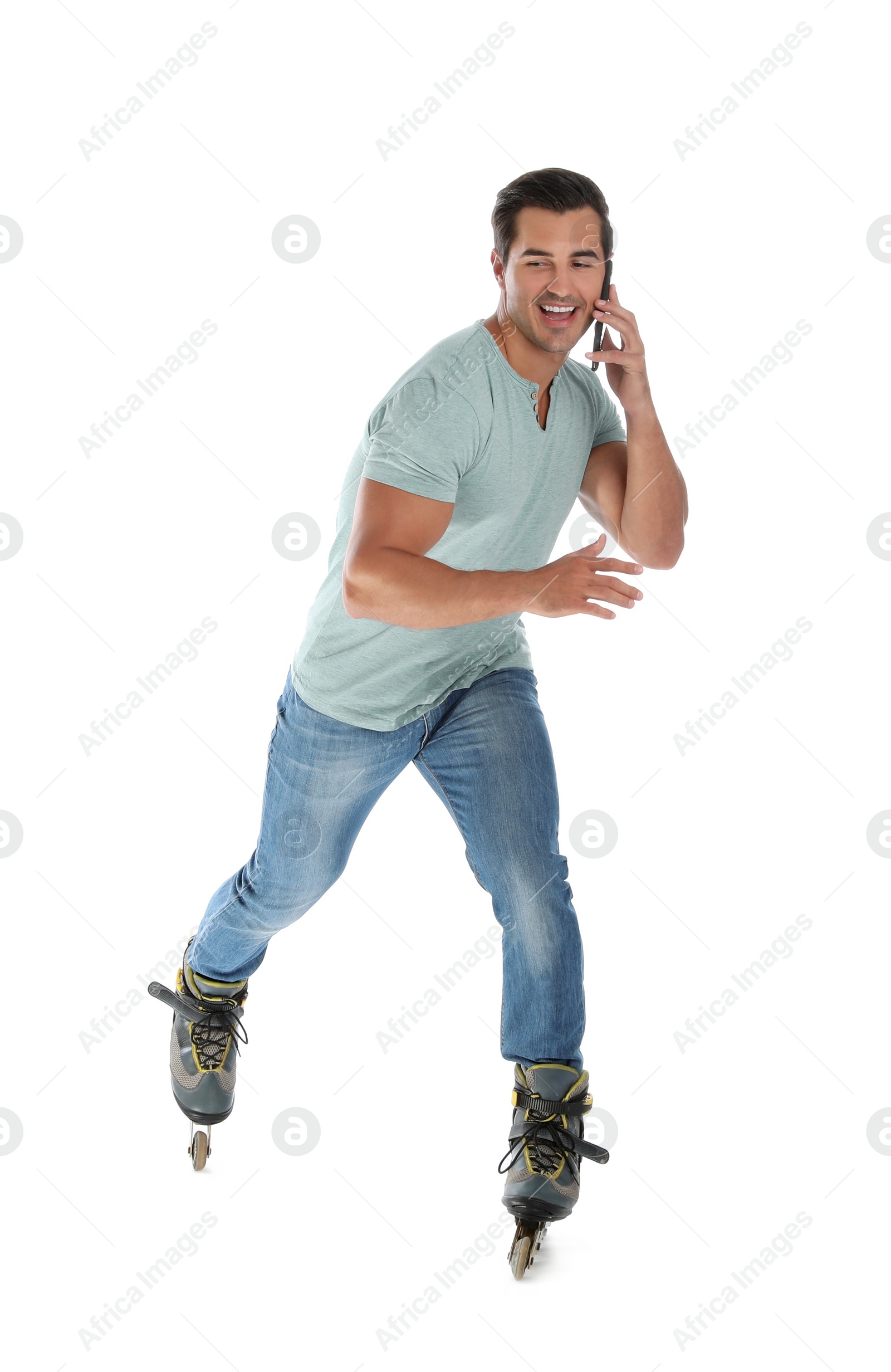 Photo of Handsome young man with inline roller skates and mobile phone on white background