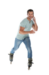 Photo of Handsome young man with inline roller skates and mobile phone on white background