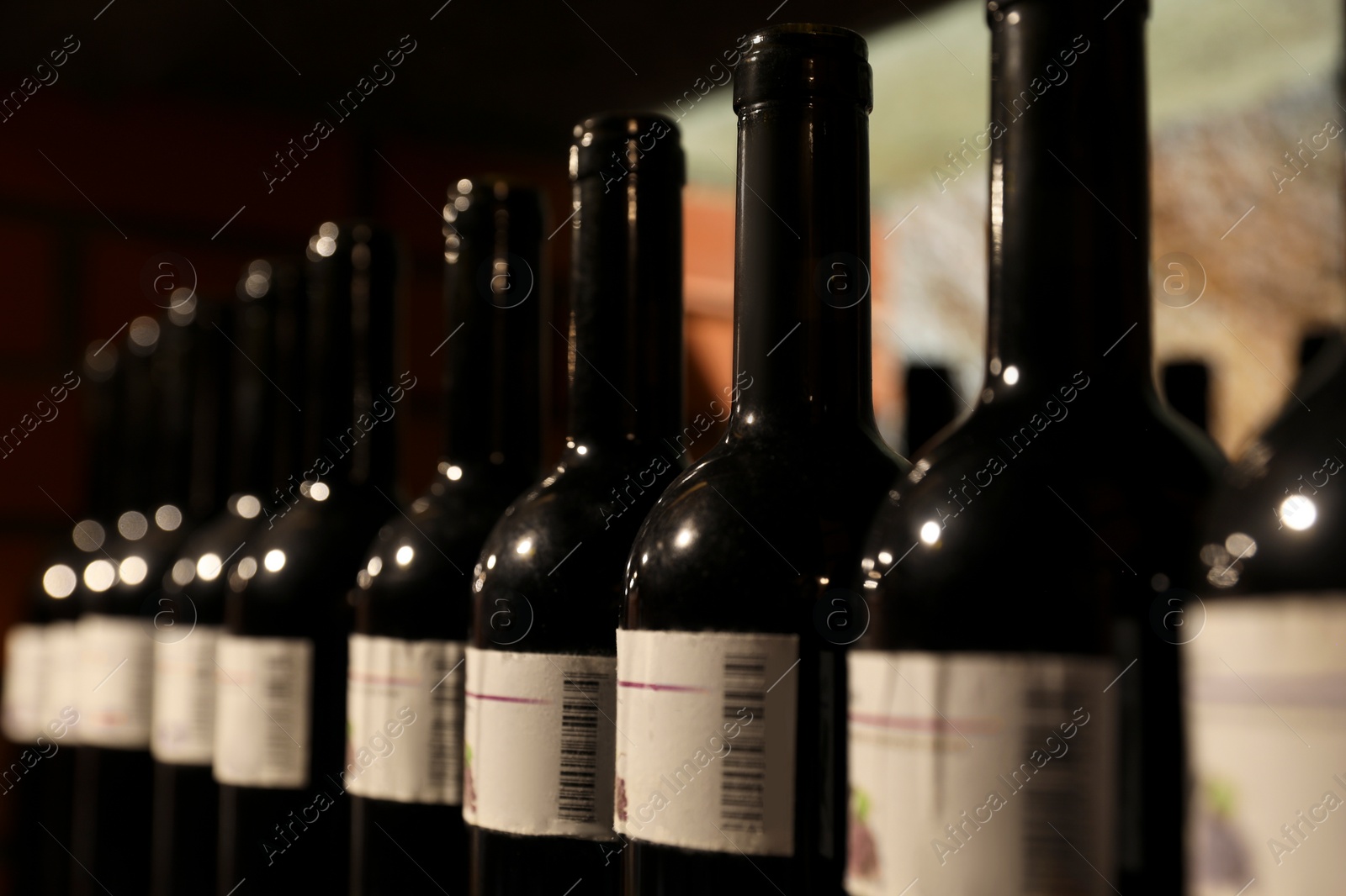 Photo of Many bottles of alcohol drinks, closeup view