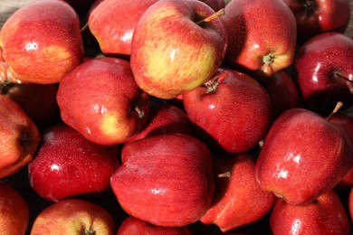 Photo of Many fresh apples with water drops as background, above view