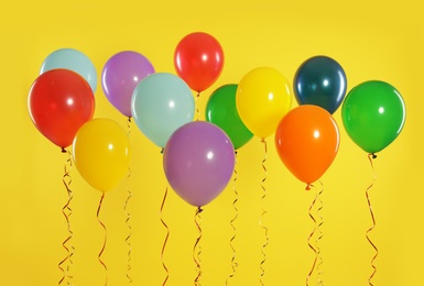 Bright balloons on color background. Celebration time