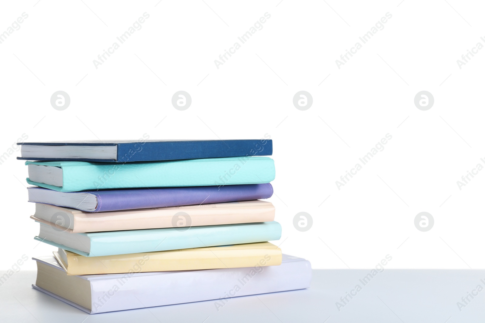 Photo of Stack of books on white background. Space for text