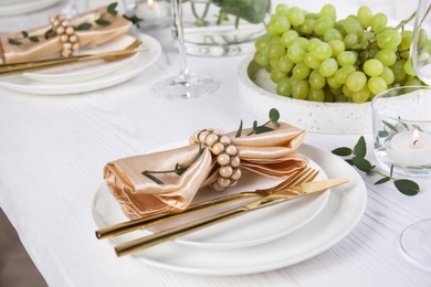 Elegant festive table setting on white wooden table