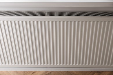 Photo of Closeup view of modern panel radiator indoors