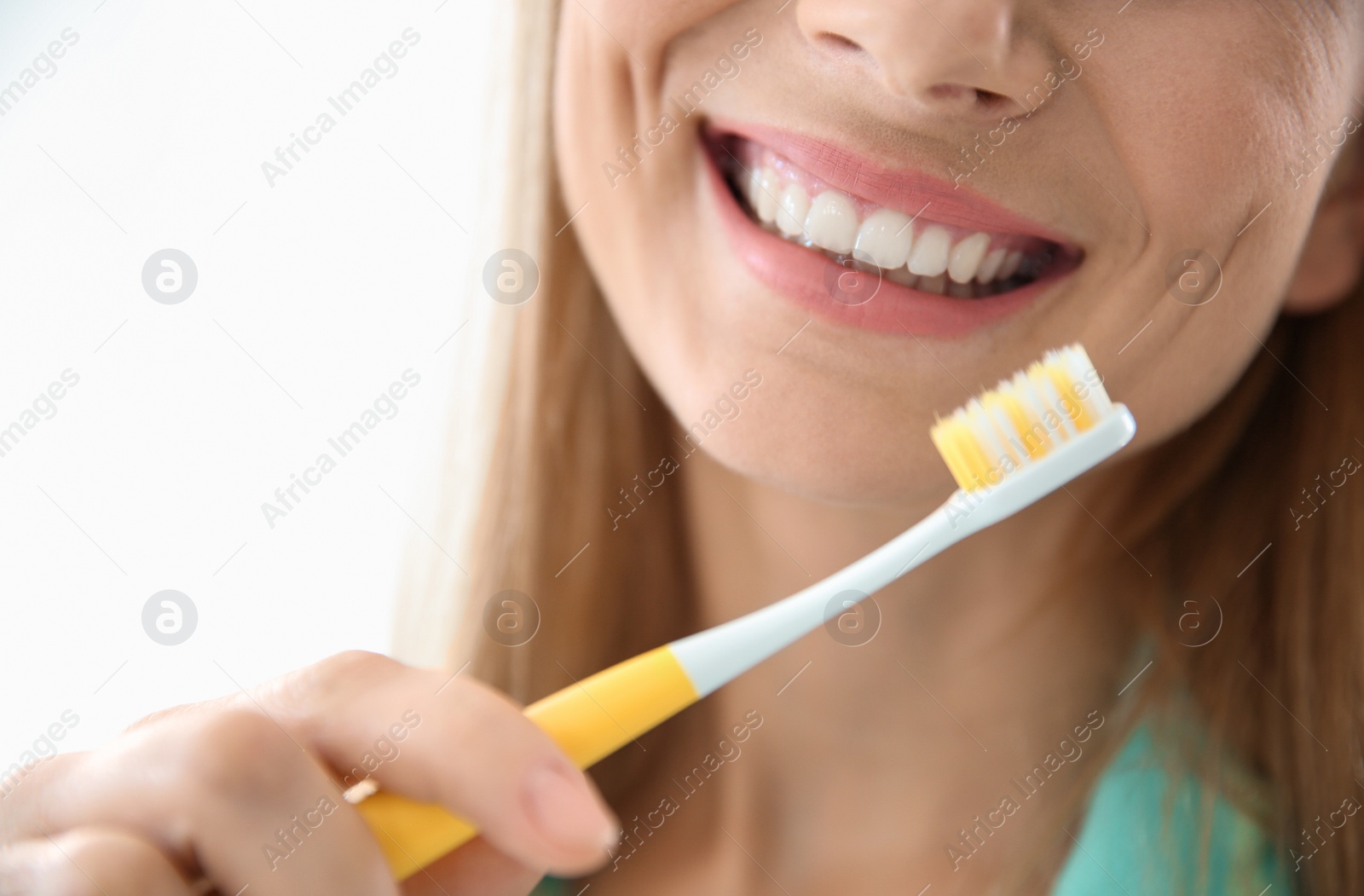 Photo of Smiling woman with toothbrush, closeup. Dental care