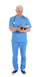 Full length portrait of male doctor in scrubs with clipboard isolated on white. Medical staff