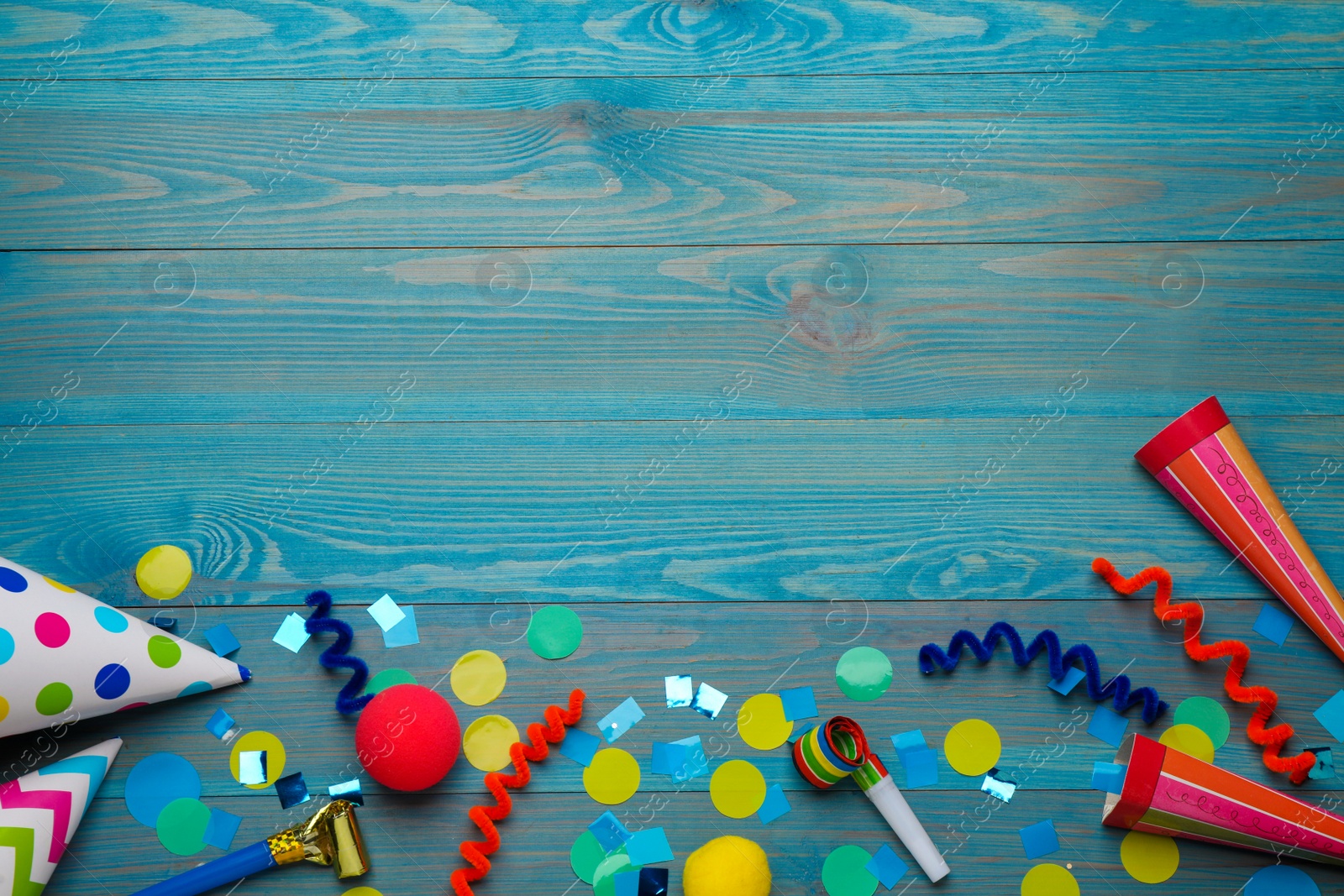 Photo of Flat lay composition with party items on light blue wooden table, space for text