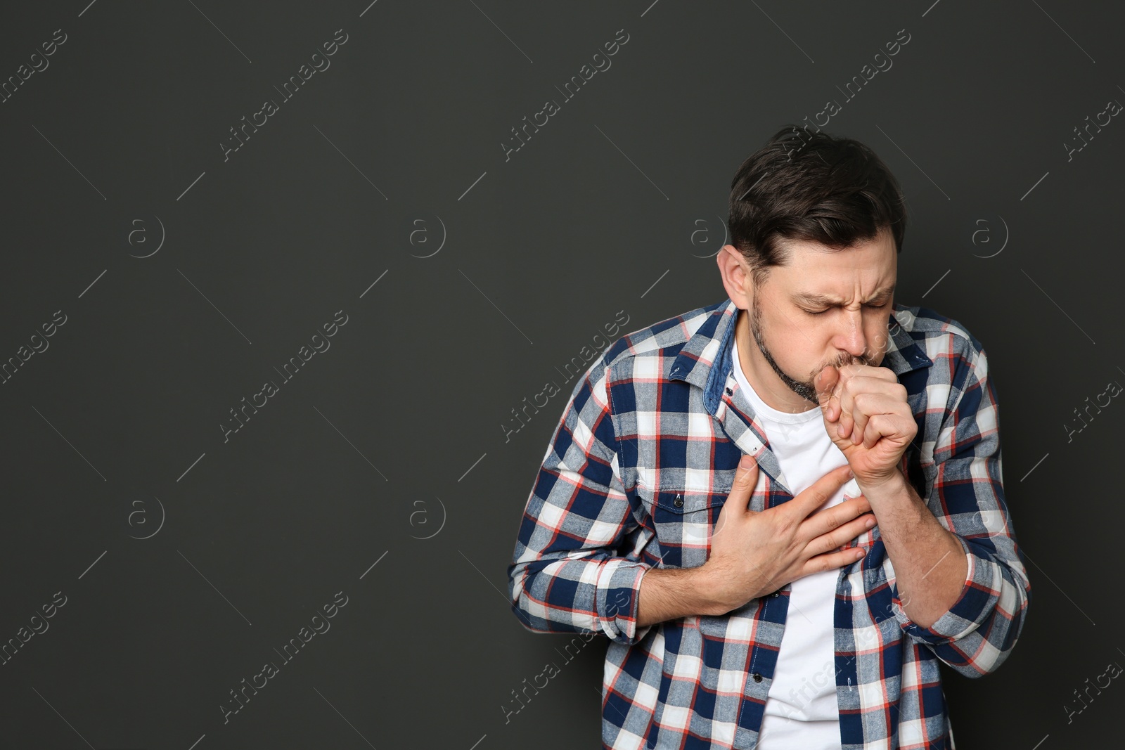 Photo of Mature man suffering from cough on dark background. Space for text