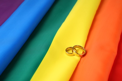 Wedding rings on rainbow flag. Gay marriage