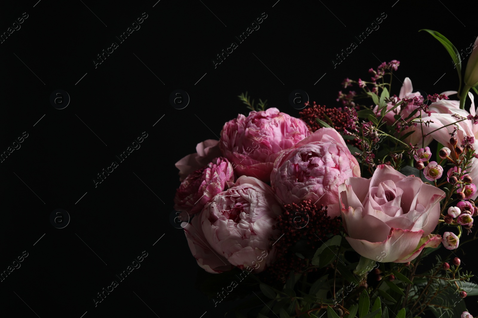 Photo of Beautiful bouquet with fresh flowers on dark background, space for text