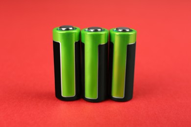 Image of New N batteries on red background, closeup