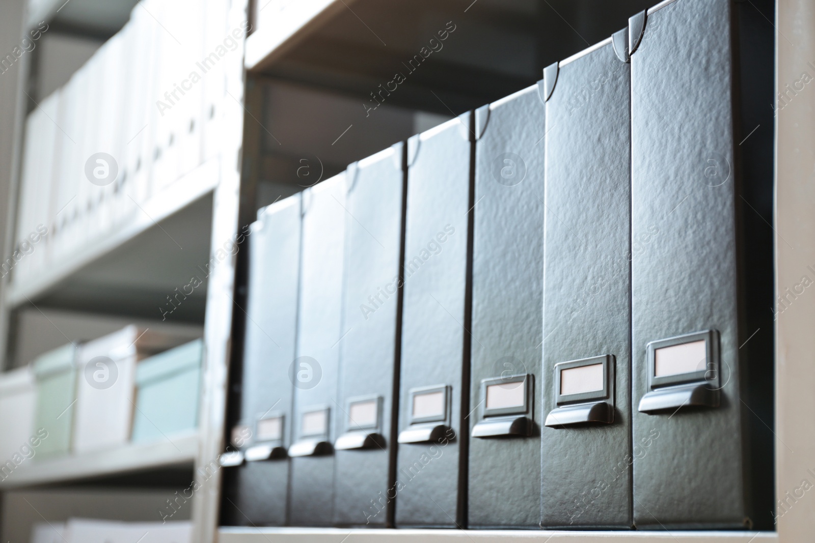 Photo of Folders with documents on shelf in archive