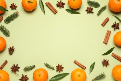 Photo of Frame made of fresh tangerines on light green background, flat lay. Christmas composition with space for text