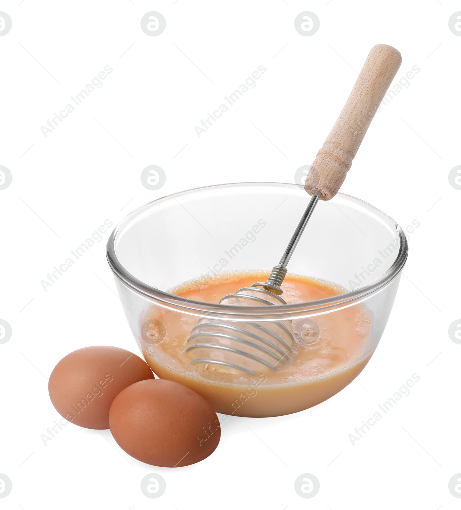 Photo of Beaten eggs and whisk in glass bowl isolated on white