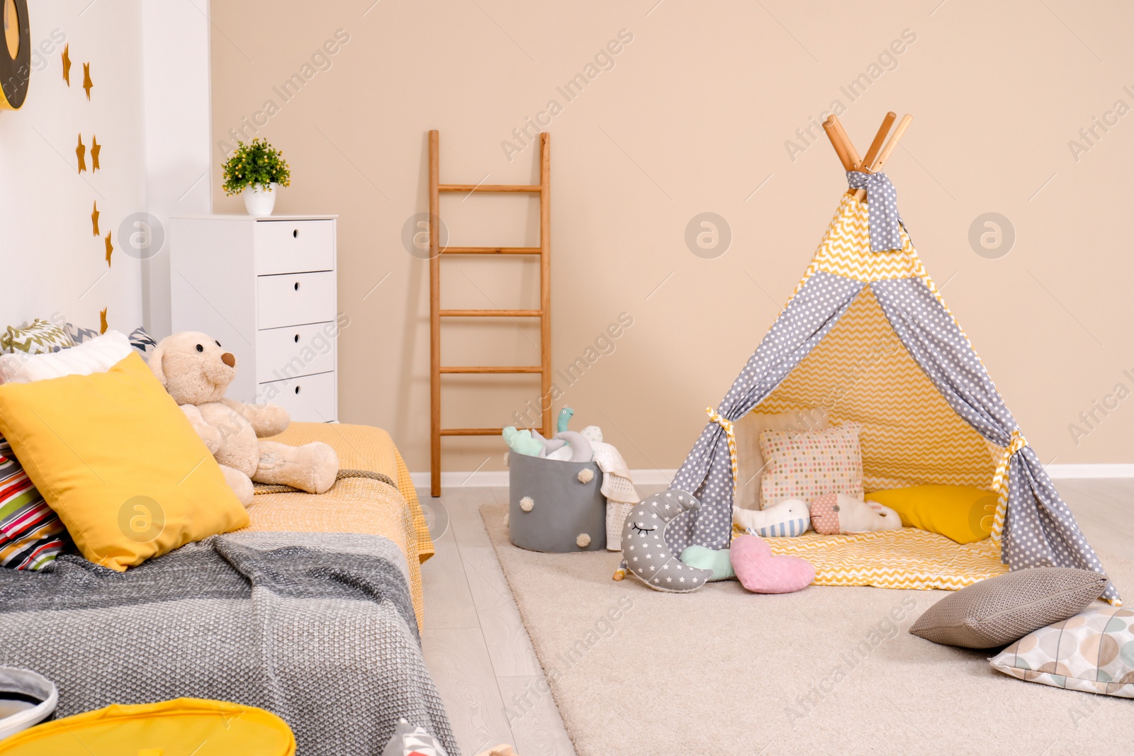 Photo of Cozy child room interior with bed, play tent and modern decor elements