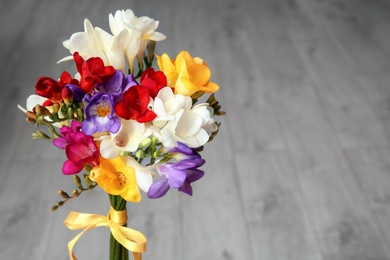 Photo of Beautiful freesia bouquet on blurred background