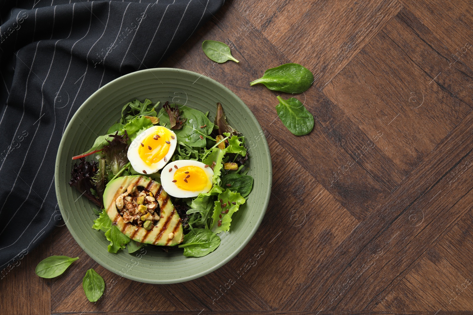 Photo of Healthy dish high in vegetable fats on wooden table, top view. Space for text