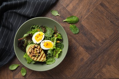 Photo of Healthy dish high in vegetable fats on wooden table, top view. Space for text