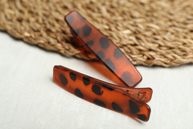 Photo of Beautiful hair clips on white table, closeup