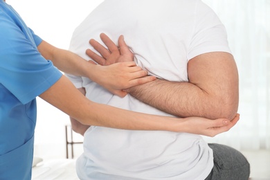 Doctor working with patient in hospital, closeup. Rehabilitation physiotherapy