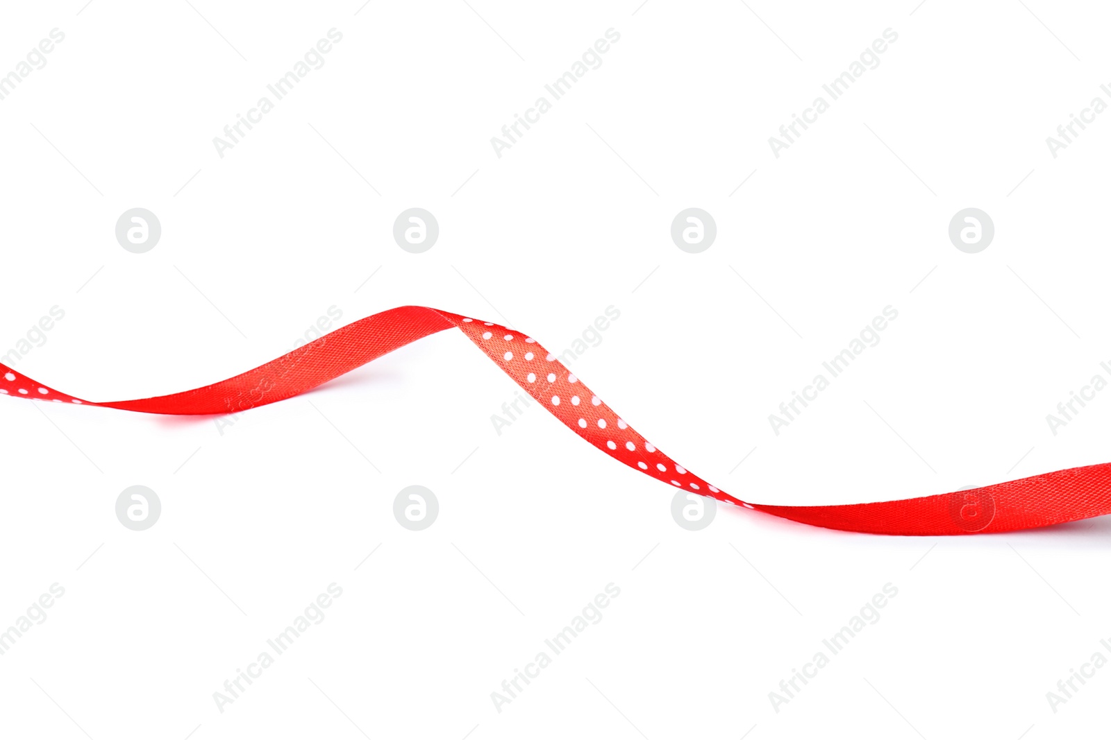 Photo of Simple red ribbon on white background. Festive decoration