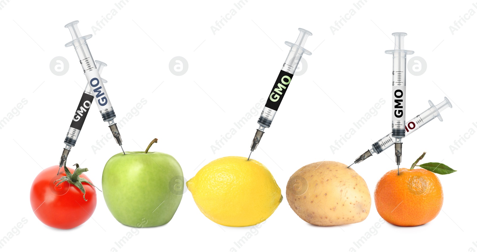 Image of Syringes with labels GMO in different fruits and vegetables on white background