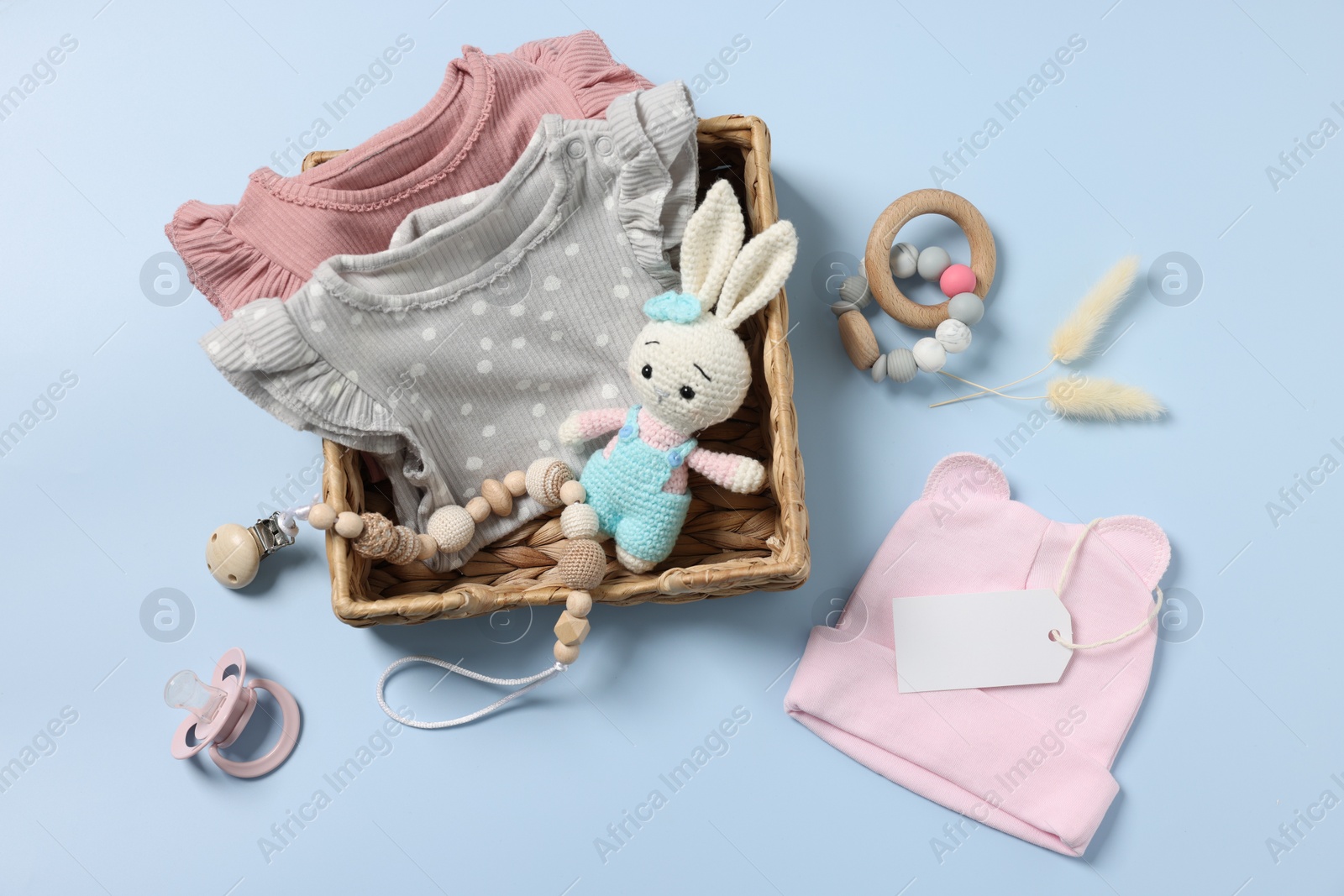 Photo of Flat lay composition with different baby accessories on light blue background